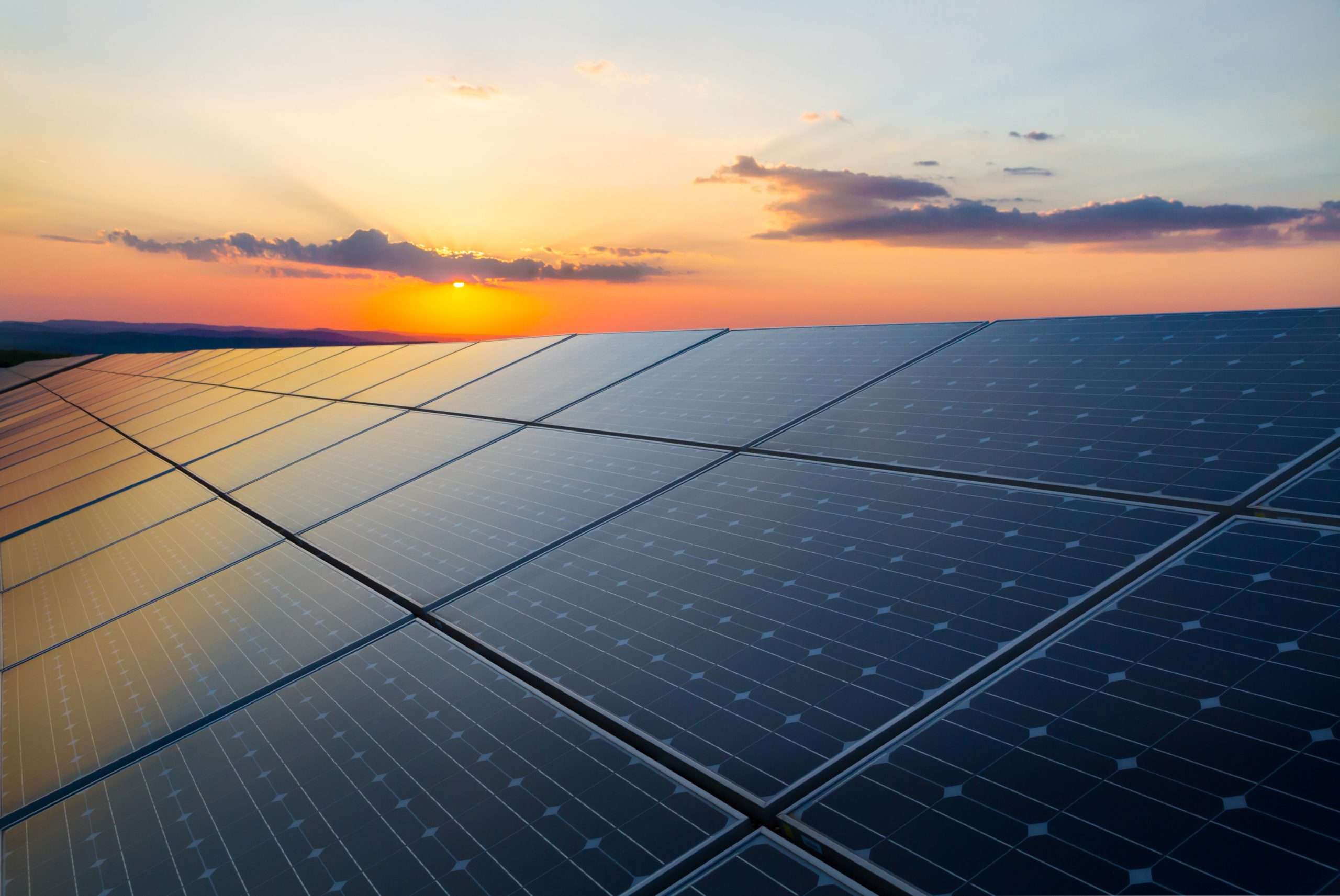 Sunset,rays,over,a,photovoltaic,power,plant